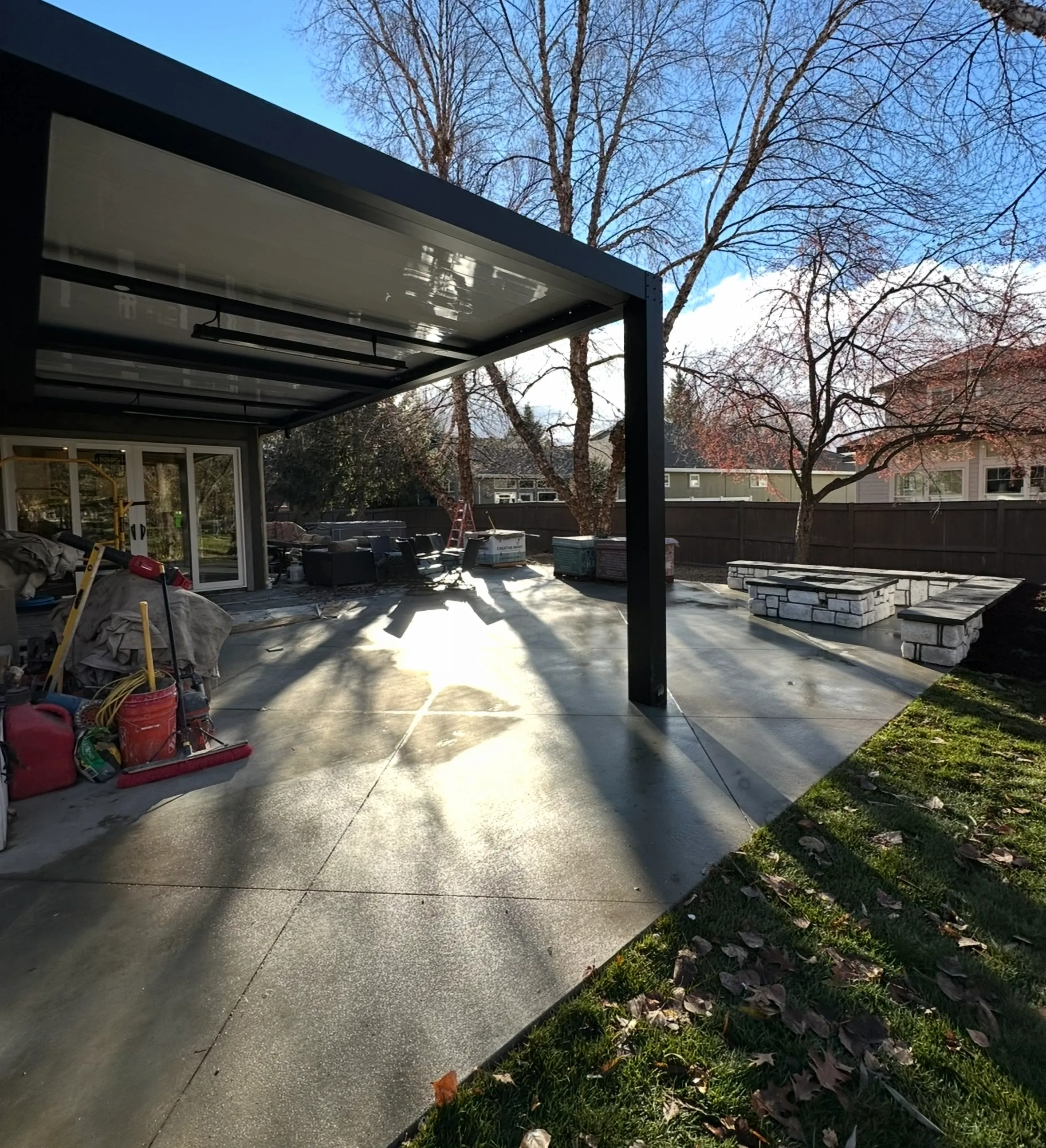 Adjustable louvered pergola extending a covered patio