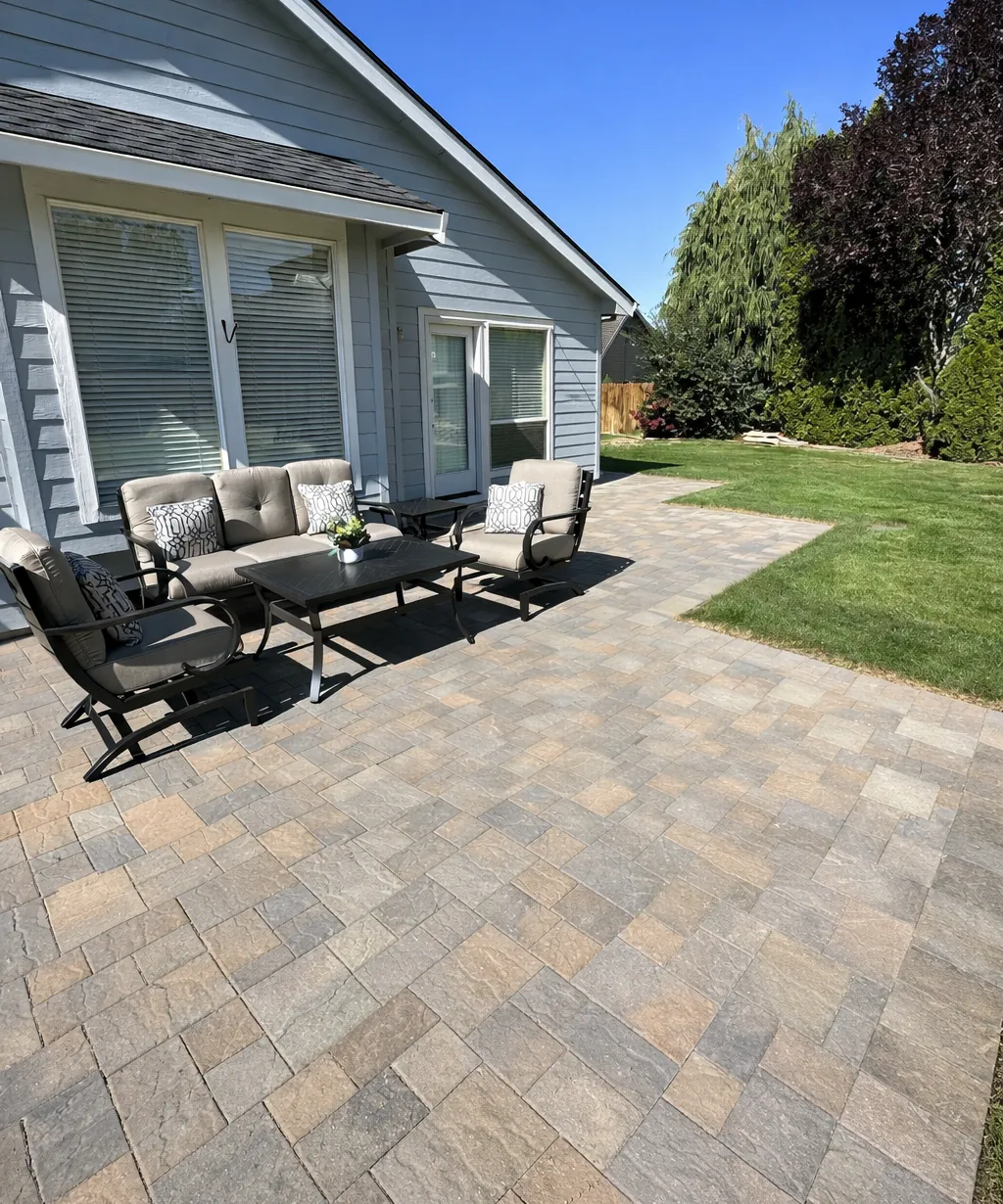Paver patio with a conversation seating area next to an open lawn