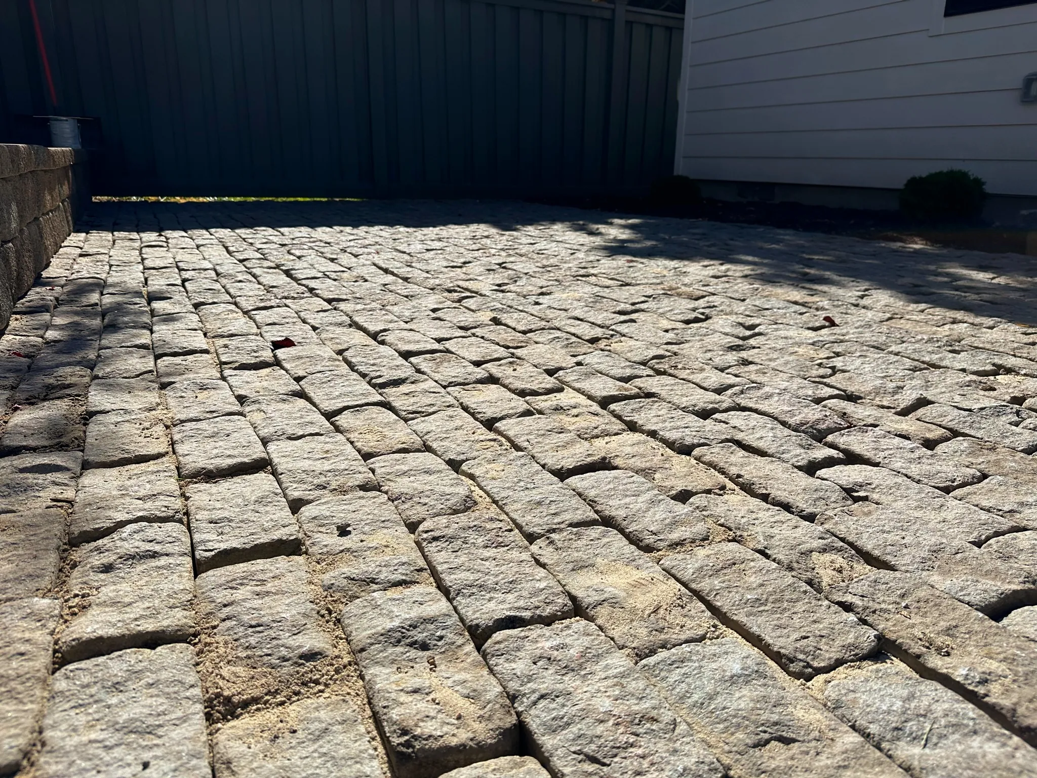 Close-up of historic granite setts salvaged and reinstalled in a backyard